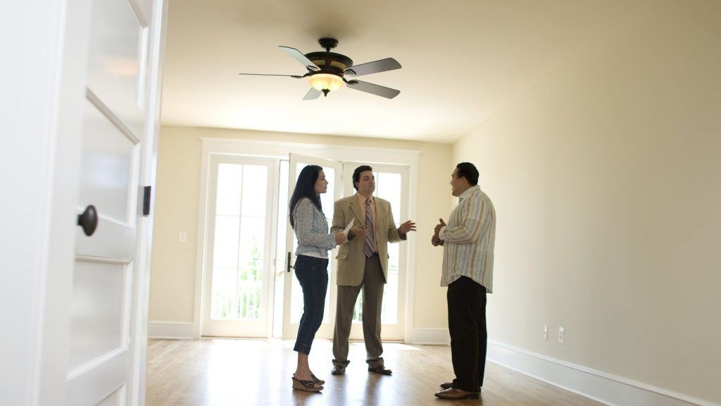 Couple with realtor looking at new home